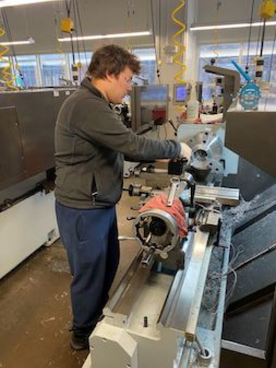 Manufacturing workforce_man with autism operates a manual lathe